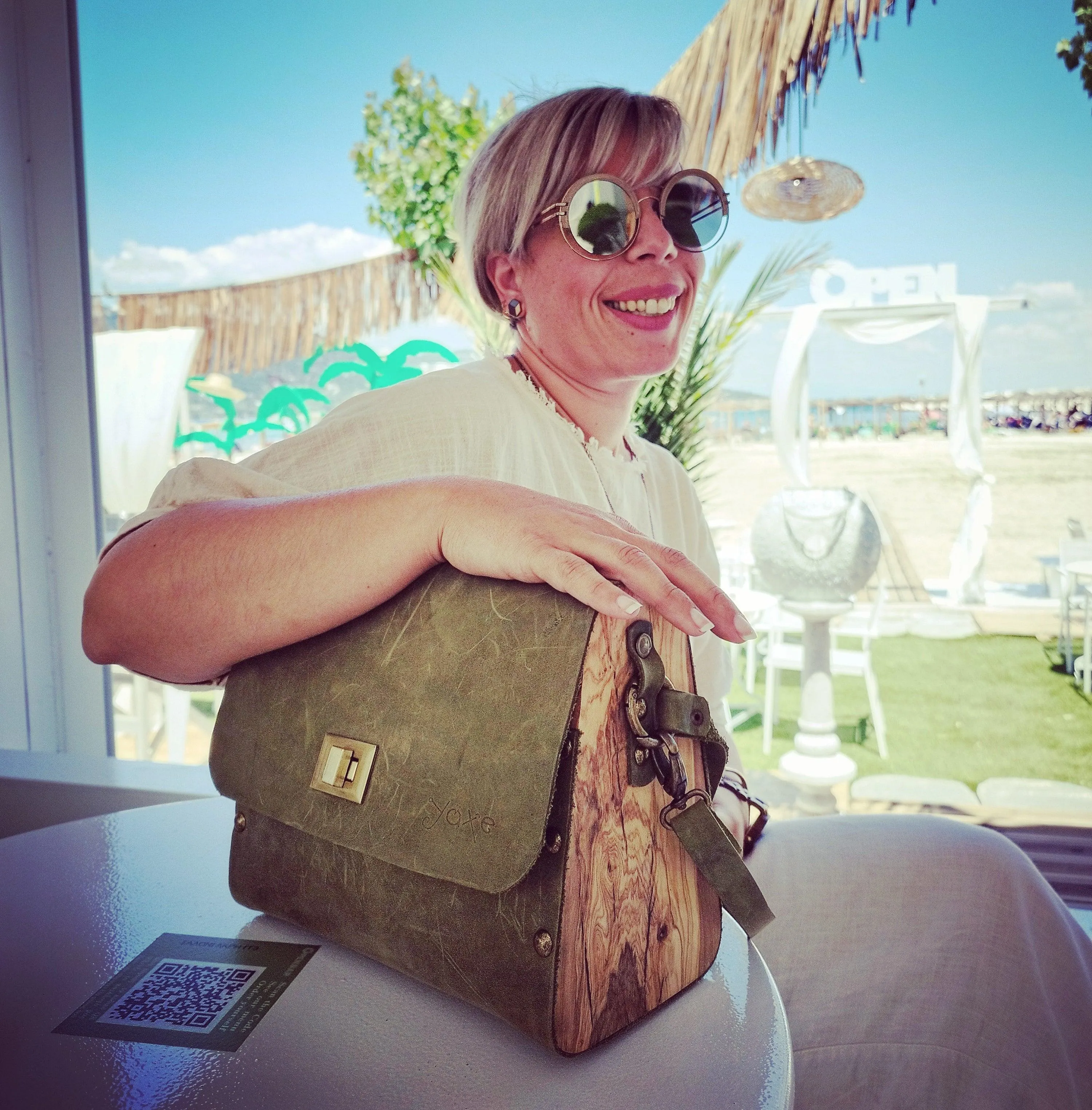 Green oil leather top handle bag and olive treee wood